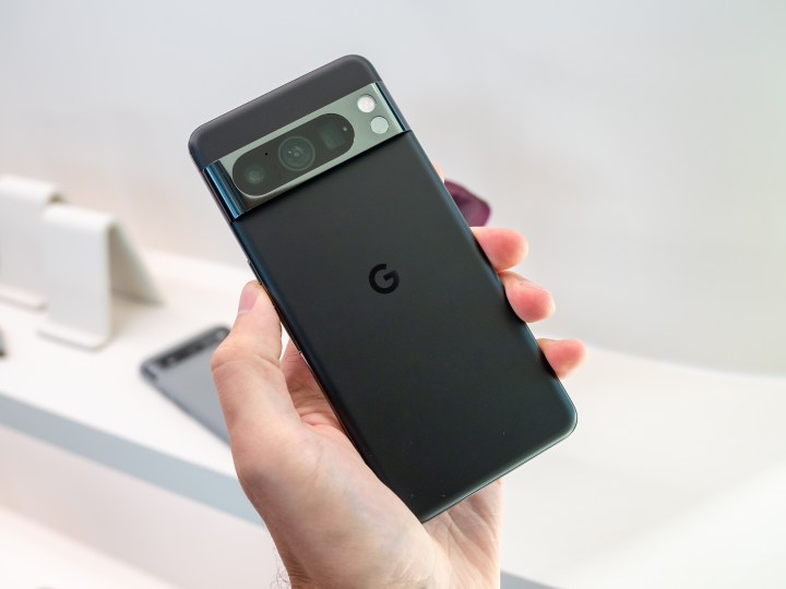 Someone holding the black Google Pixel 8 Pro.