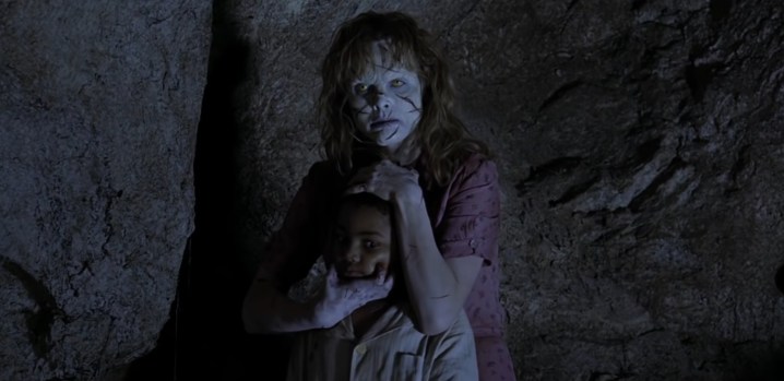 Sarah is holding a baby in her arms "Exorcist: Beginning."