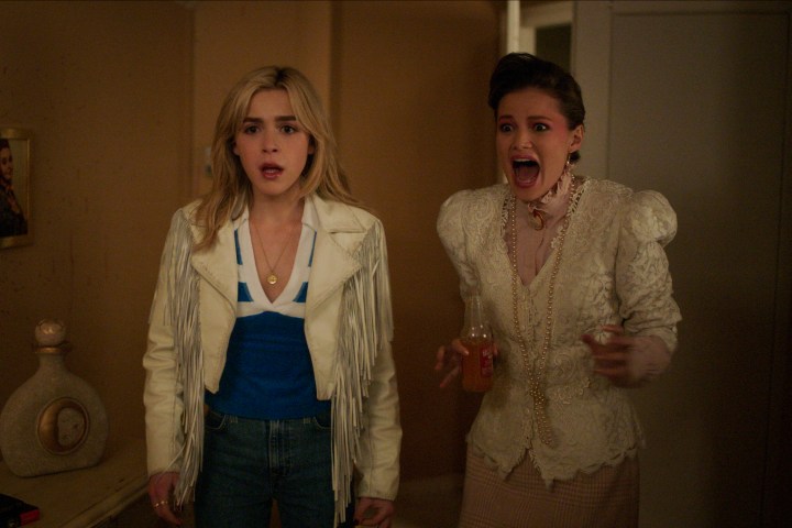 Olivia Holt screams next to Kiernan Shipka in Totally Killer.