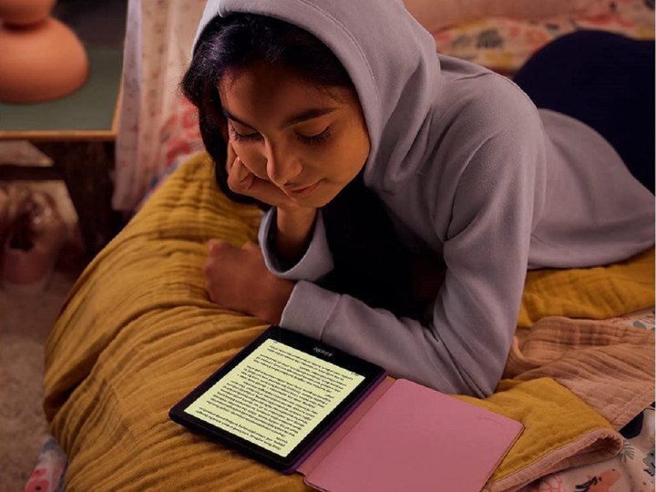 A girl reading an e-book on an Amazon Kindle Paperwhite Kids.