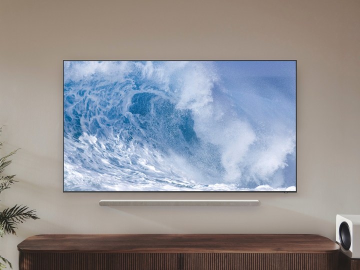 Samsung QN700B QLED 8K TV mounted on a wall, with a ripple on the screen.