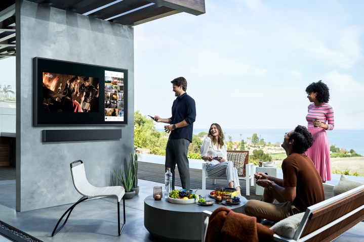 A family watching TV outdoor.