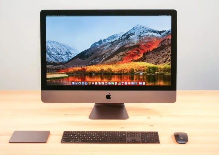 An Apple iMac Pro on a desk, with a macOS High Sierra desktop on the screen.