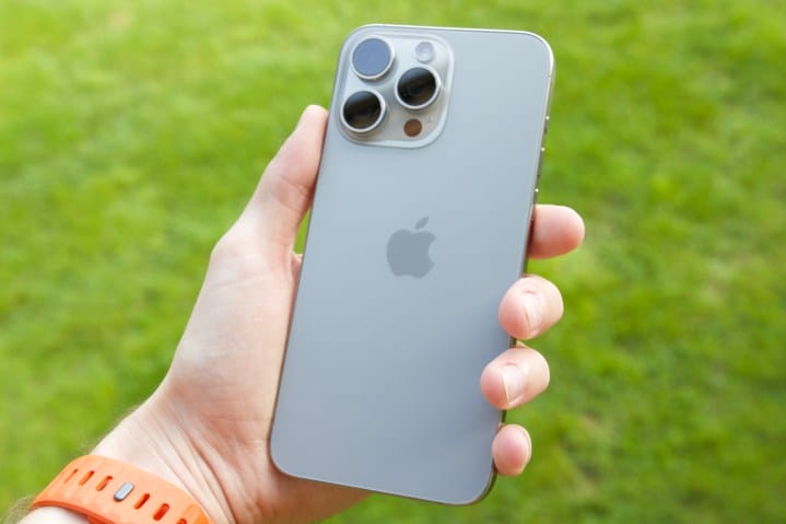 Someone holding the Natural Titanium iPhone 15 Pro Max.