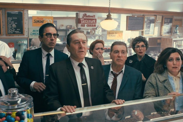 Robert De Niro and Al Pacino standing in a deli in The Irishman.