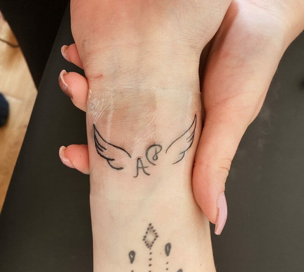 Tiny Angel Wings Tattoo