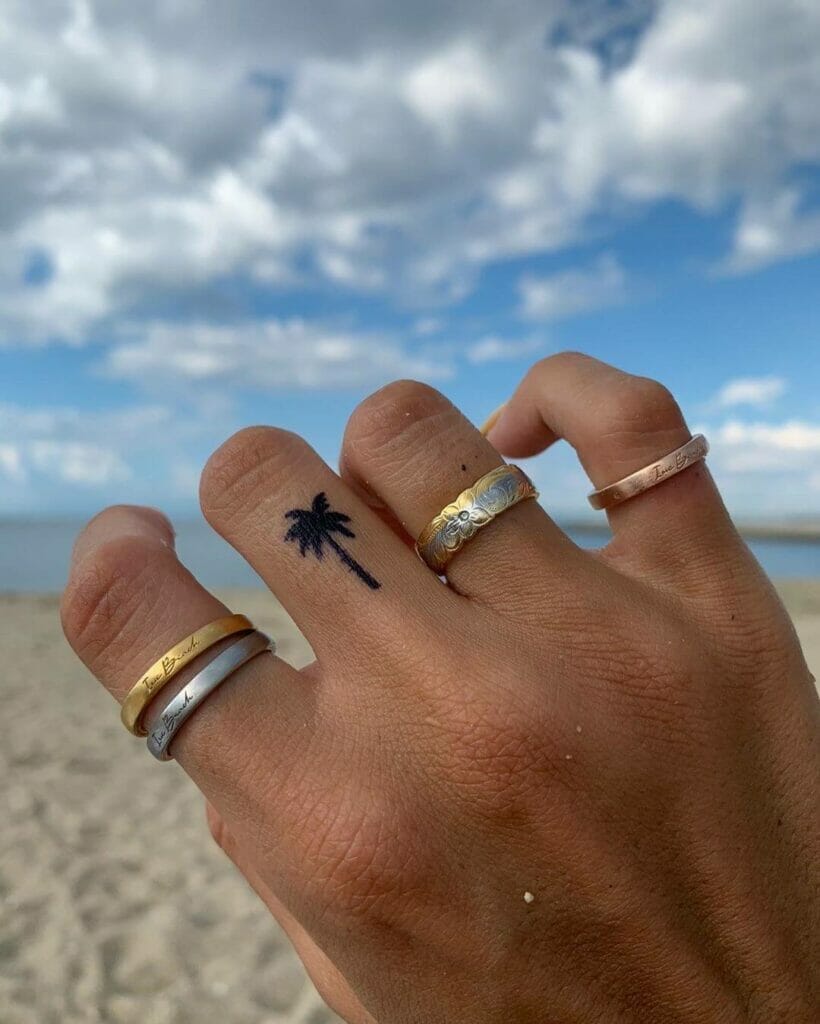 Minimalist small palm tree tattoo