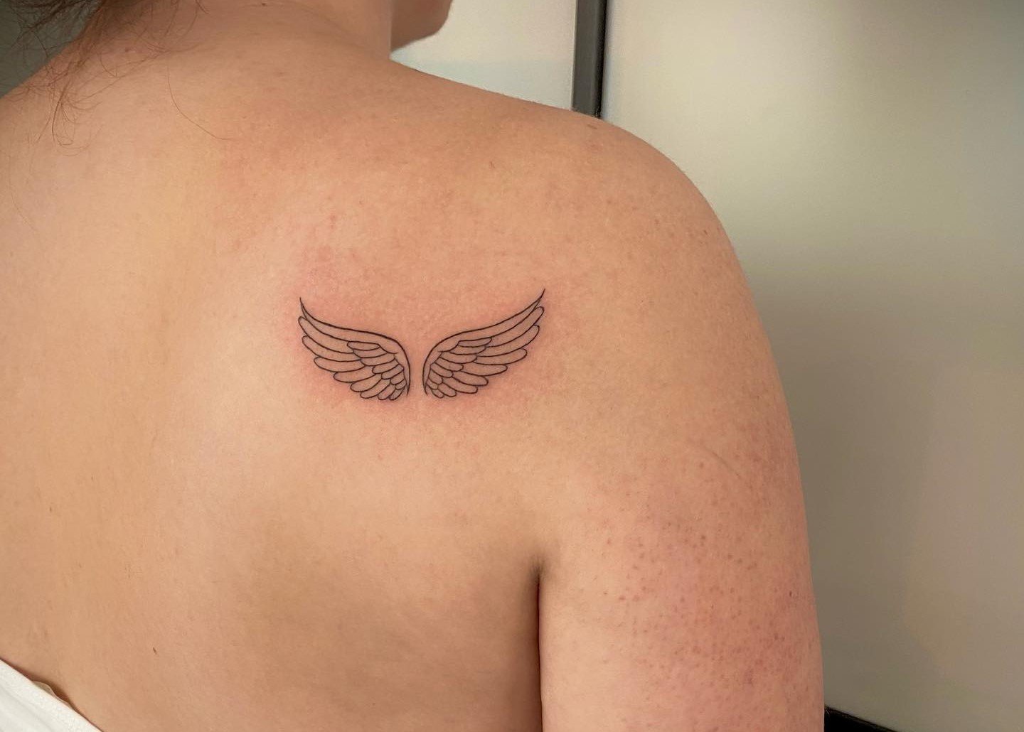 Tiny Angel Wing Tattoo