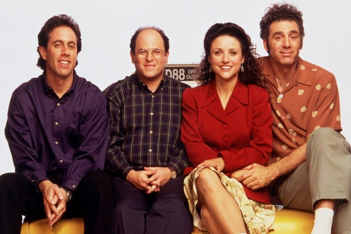 cast of "seinfeld" Sitting on a sofa.