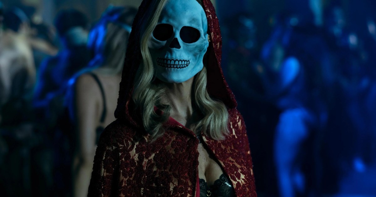 A blonde haired woman wears a skull mask in The Fall of the House of Usher