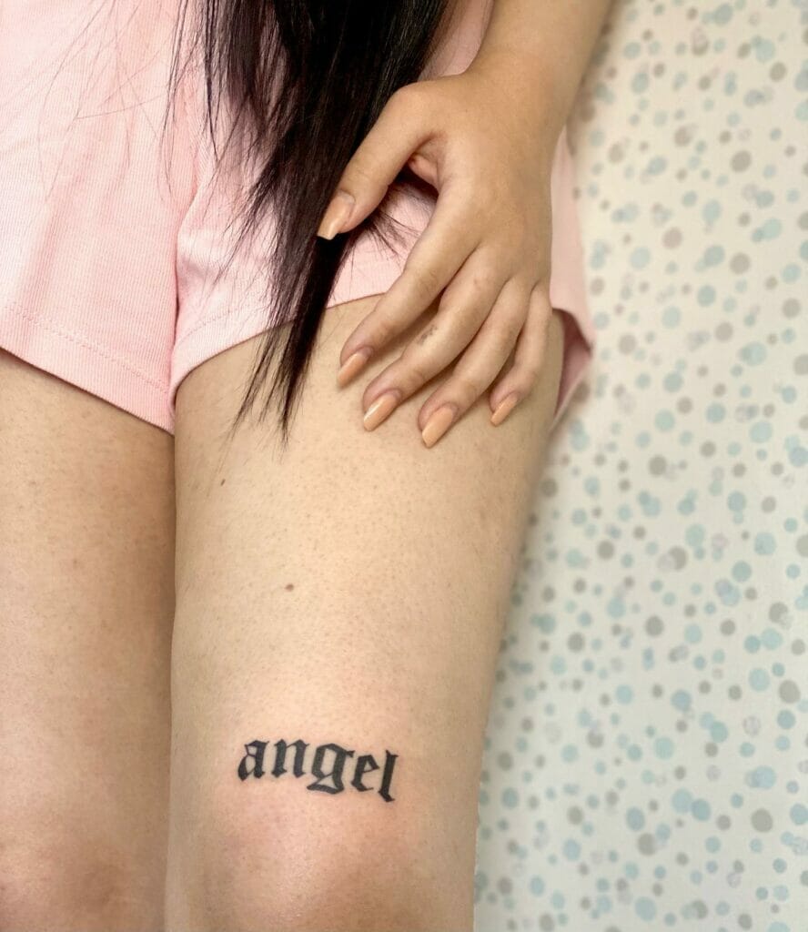 Angel name tattoo on lower thigh