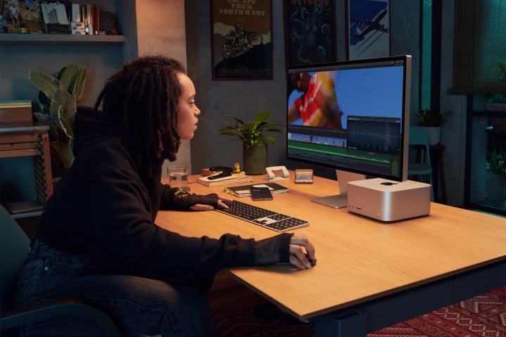 Apple Studio display with a Mac Studio computer on a desk.