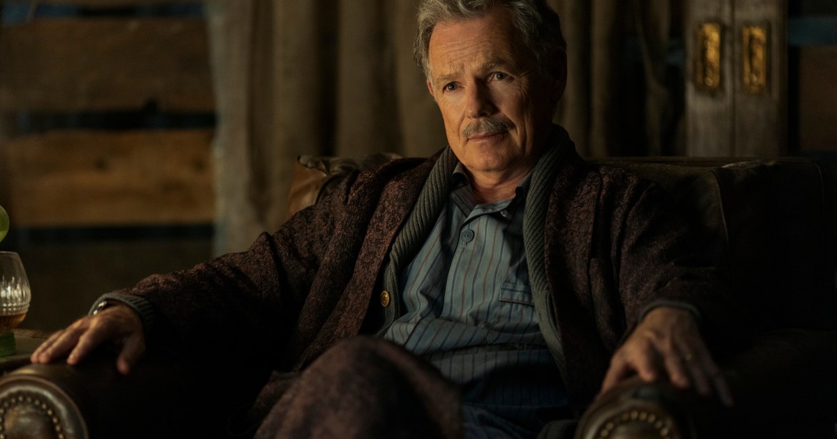 Bruce Greenwood sits in a chair in The Fall of the House of Usher