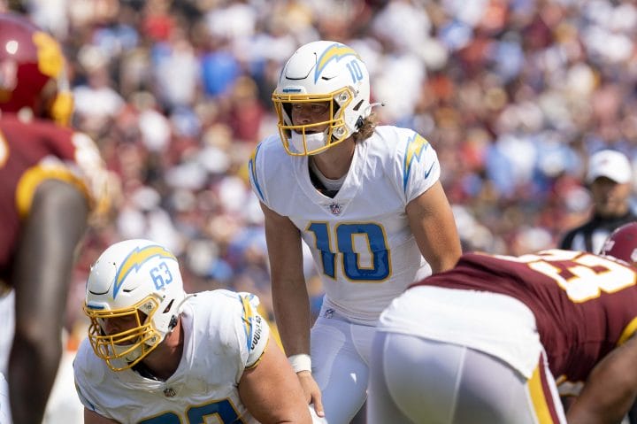 Justin Herbert is lining up at line of scrimmage for the Chargers.