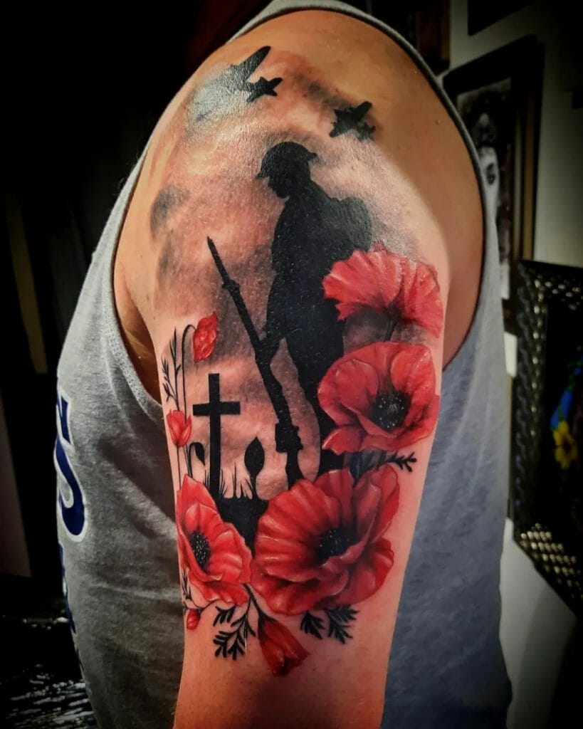 Memorial tattoo featuring a soldier's silhouette with red poppies, grave crosses, and planes flying overhead on the upper arm