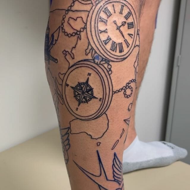 Linework tattoo featuring a compass, a pocket watch with Roman numerals, and a world map outline, symbolizing exploration and travel