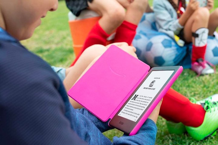 A child reads outside on Amazon Kindle Kids Edition.