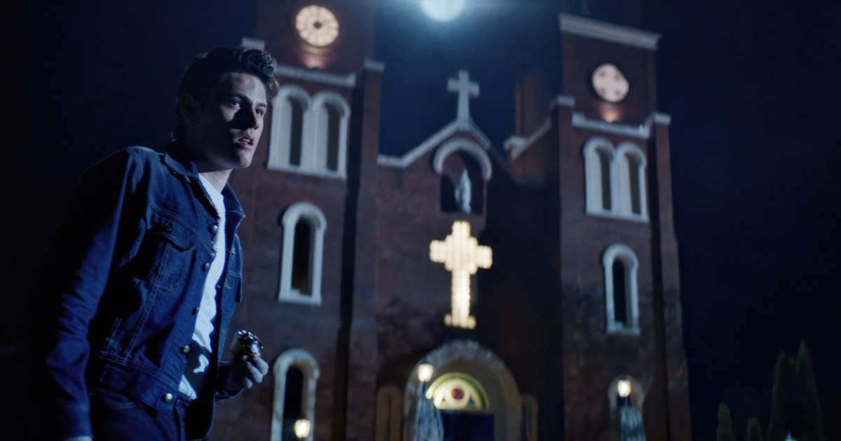 Richie stands near a church in Dark Harvest