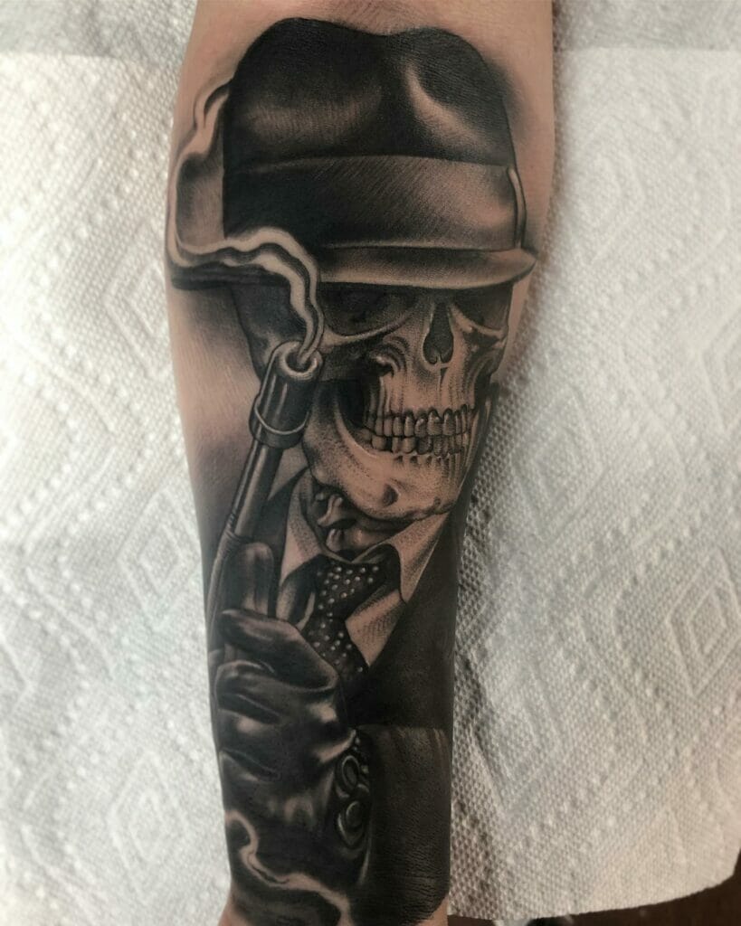 Skull tattoo with gangster face and gun