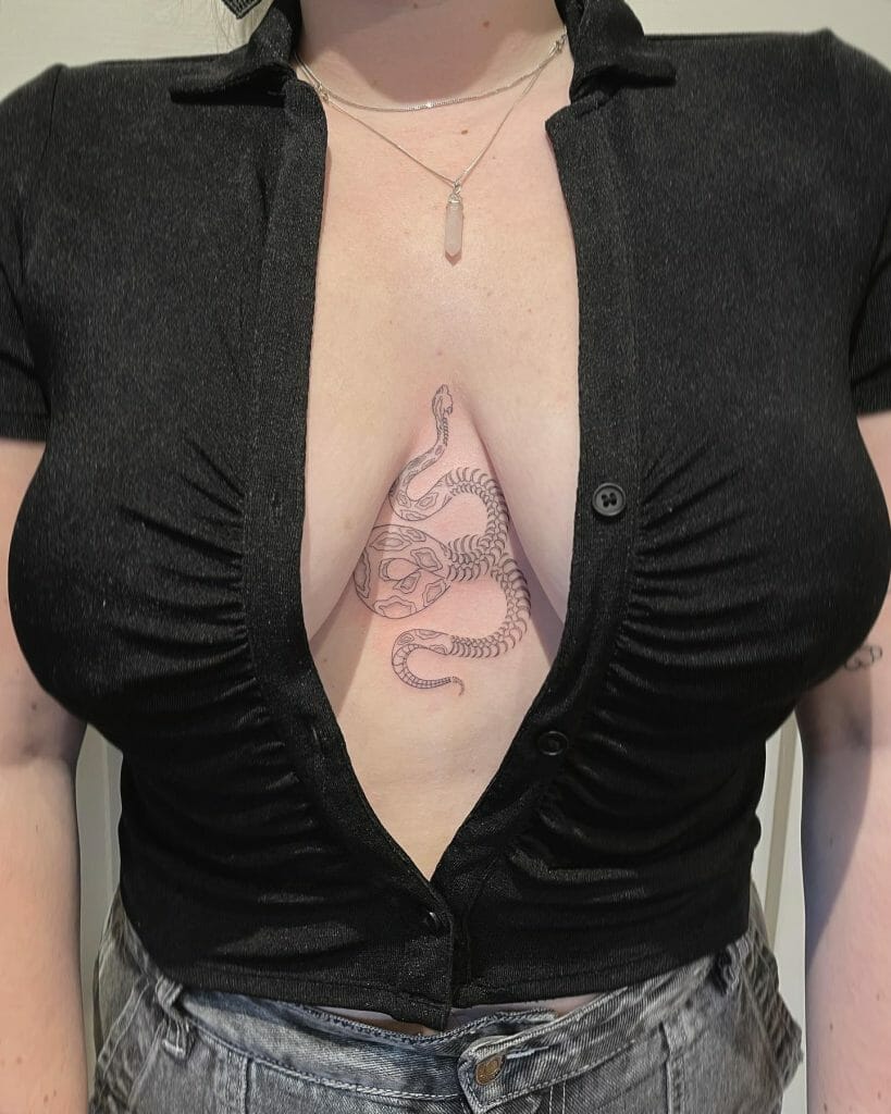 Under-breast tattoo featuring a minimalist snake wrapped around a skull design, symbolizing rebirth and transformation