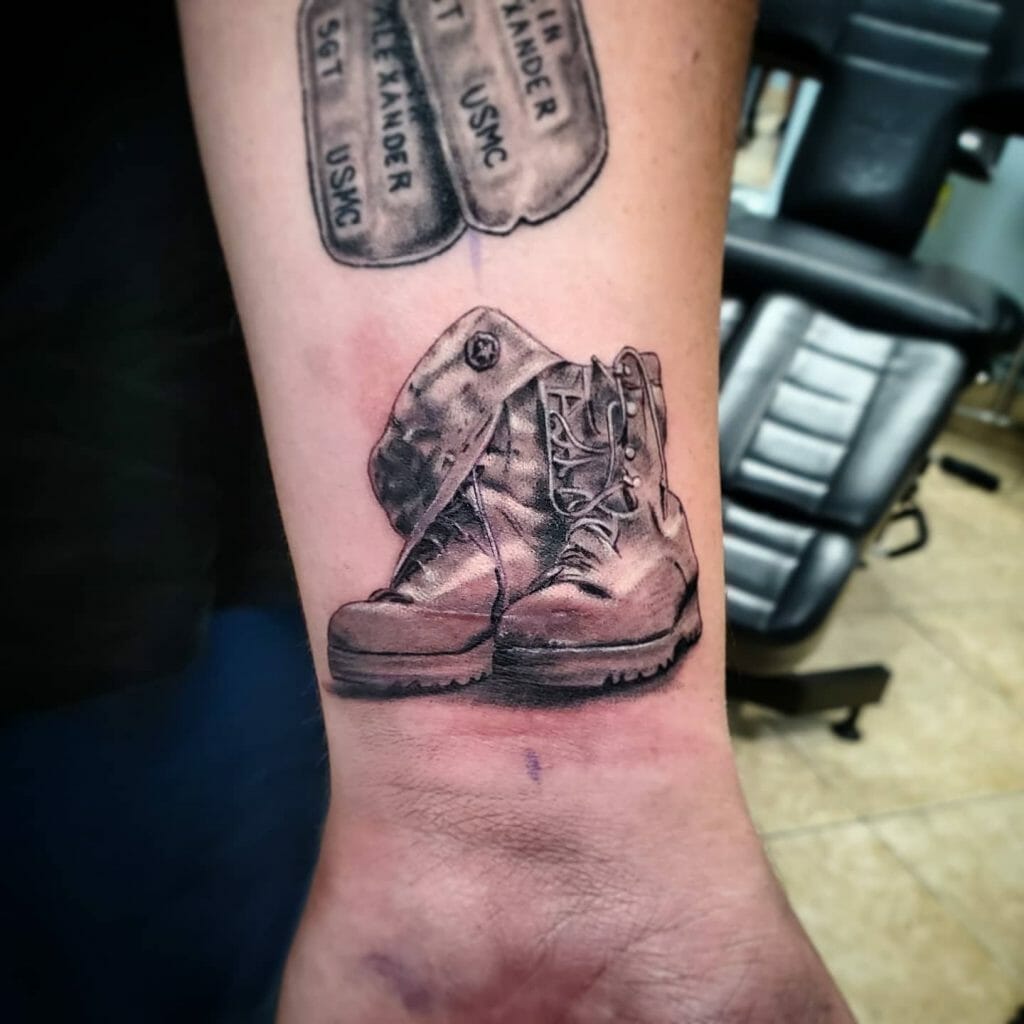 Military boots and dog tags memorial tattoo in black and grey, symbolizing a tribute to a fallen soldier