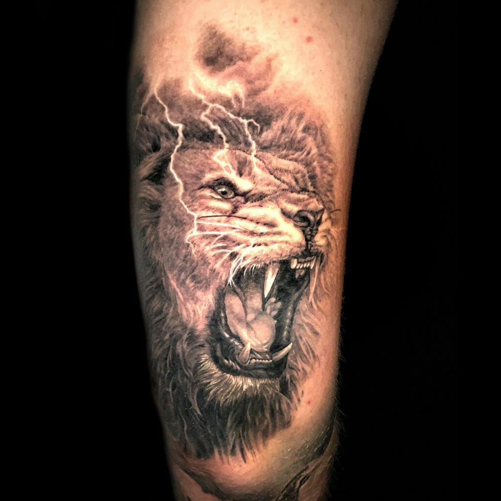 Thigh tattoo of a roaring lion with lightning, symbolizing raw power, intensity, and strength.