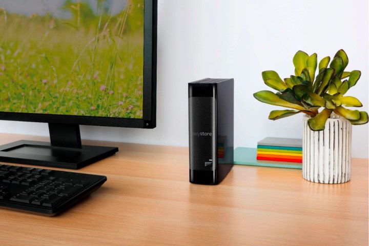 A WD Easystore external hard drive next to a desktop computer.