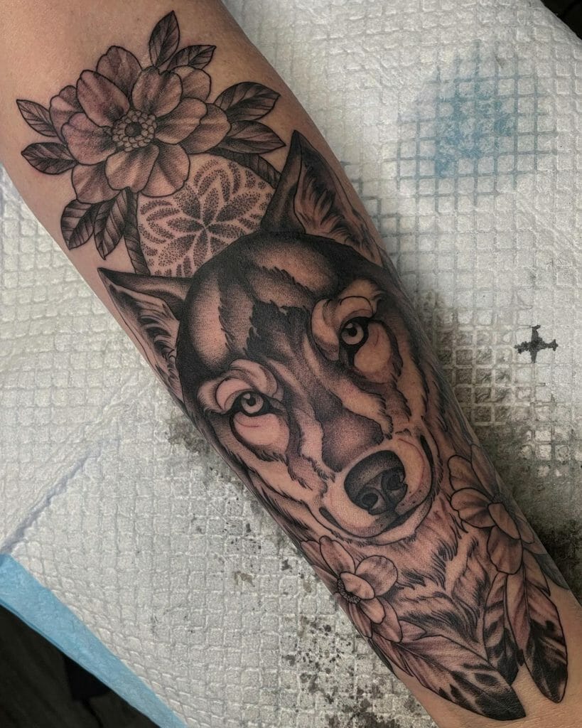 Wolf tattoo design with flowers.