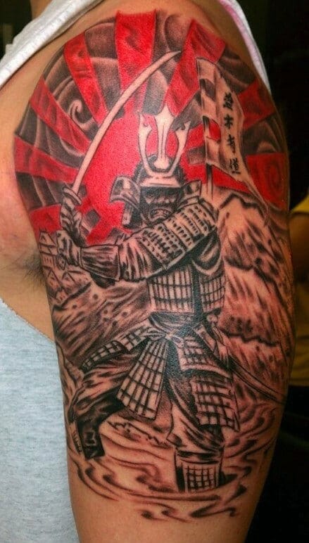 Bold tattoo of a samurai warrior with a sword and rising sun background on upper arm, symbolizing honor and power