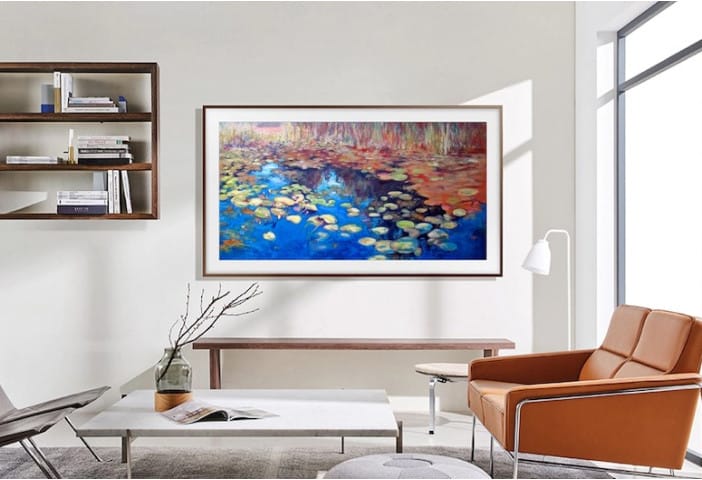 A 50-inch Samsung Frame TV hangs on the living room wall, displaying art.