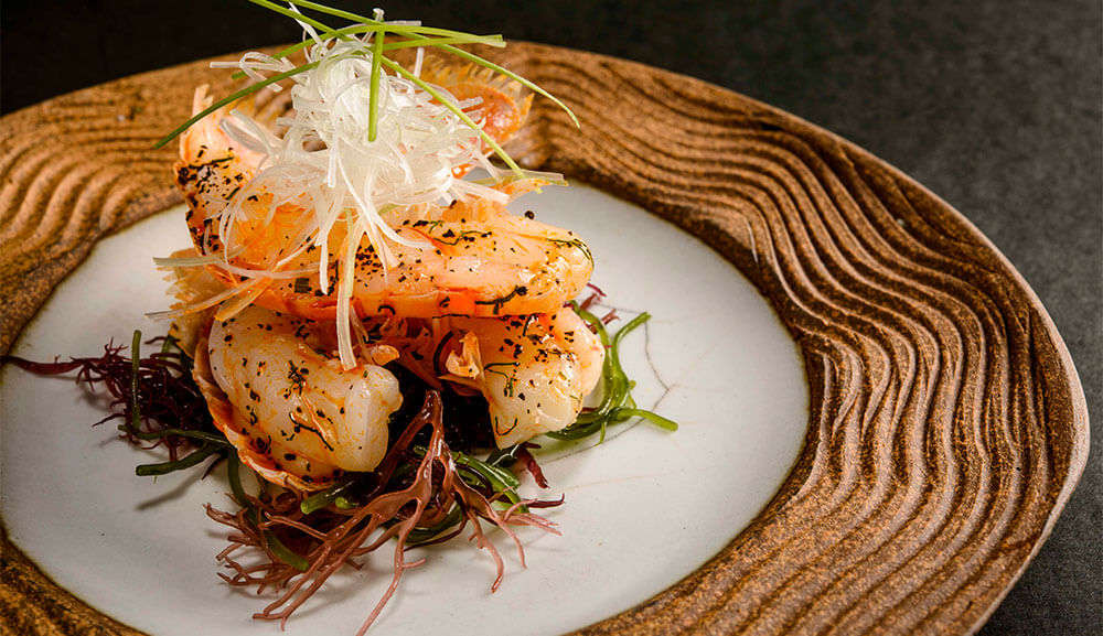 fish dish on a white and brown plate