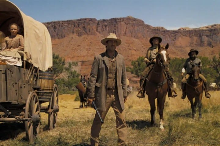 Cowboys stand in a field in Horizon: An American Saga.