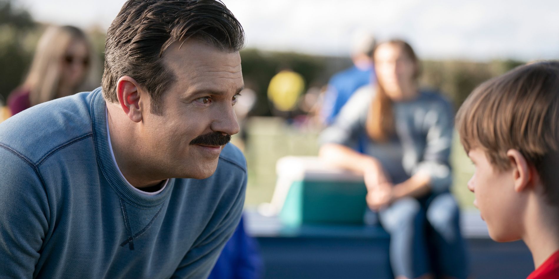 Ted (Jason Sudeikis) speaking with his son Henry (Gus Turner) on the pitch in the Ted Lasso season 3 finale