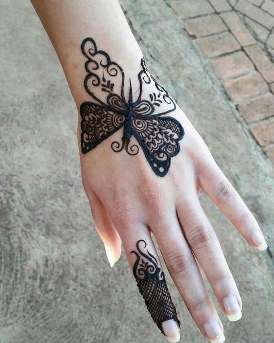 Butterfly Mehndi design on the back of the hand with intricate wing patterns and fine finger detailing, ideal for modern occasions