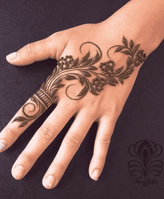 Floral vine Mehndi design on the back of the hand with delicate leaf patterns, perfect for minimalist and modern occasions