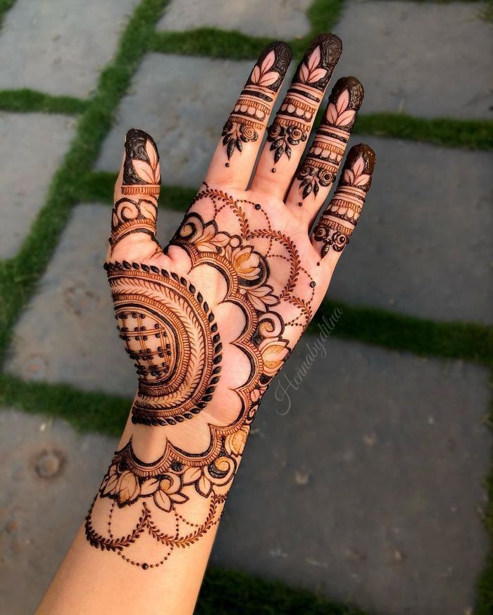 Circular floral Mehndi design on the palm with delicate patterns extending to the fingers, ideal for simple bridal or festive occasions.