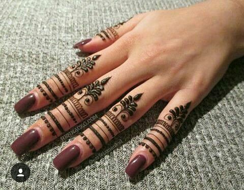 A simple yet royal Mehndi design featuring band-like patterns and leaf motifs across the fingers, accentuated with bold details and intricate dot work