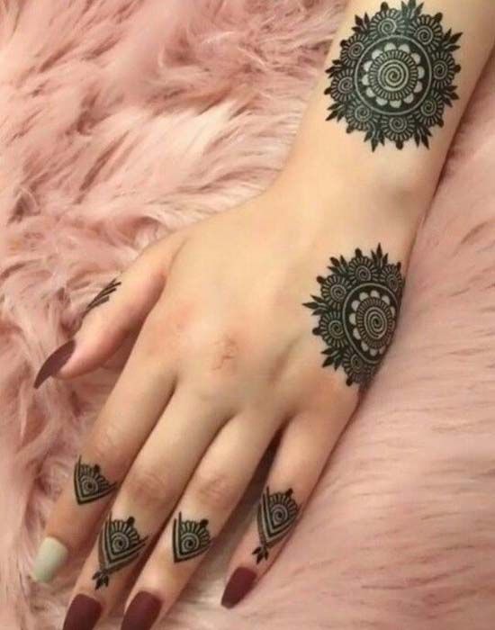 Mandala-inspired Mehndi design with bold circular motifs on the hand and geometric patterns on the fingers, ideal for modern occasions