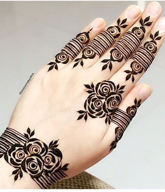 Rose Mehndi design with bold floral motifs and geometric band detailing on the fingers, ideal for modern and minimal occasions