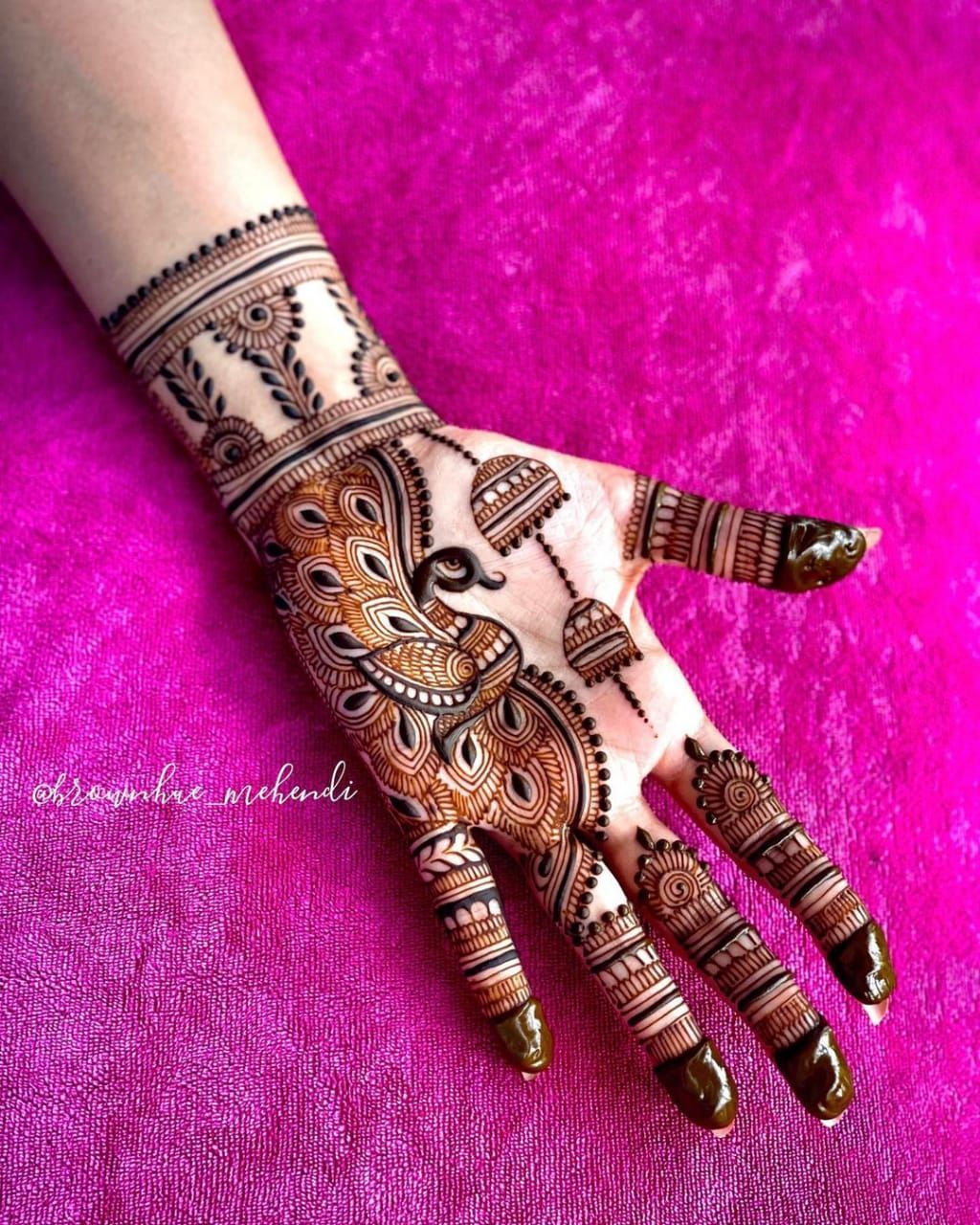 Peacock motif Arabic Mehndi design with detailed patterns and floral accents, perfect for bridal and festive occasions