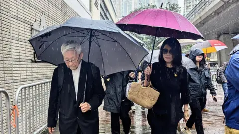 Jimmy Lai's wife Teresa (right) and retired Chinese cardinal Joseph Zen arrive to attend Lai's trial