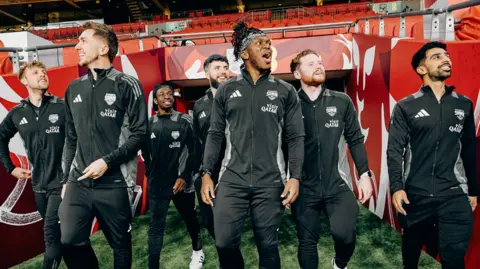 The Sidemen The Sidemen group walking out on the Wembley Stadium football pitch