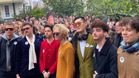 Getty Images Seven men at a Harry Styles lookalike competition in London 