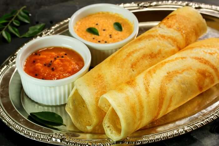 Crispy Dosa Ghee Roast served with Kerala-style sambar and coconut chutney on a silver platter