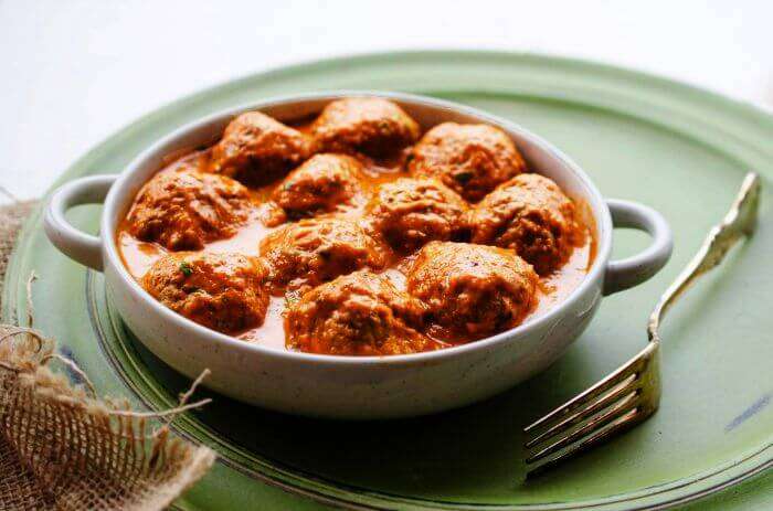 Turkish kofte meatballs in a rich tomato-based sauce served in a bowl.