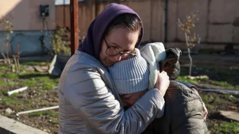 Getty Images Two female residents in Odesa comfort each other after a Russian missile strike on November 17, 2024