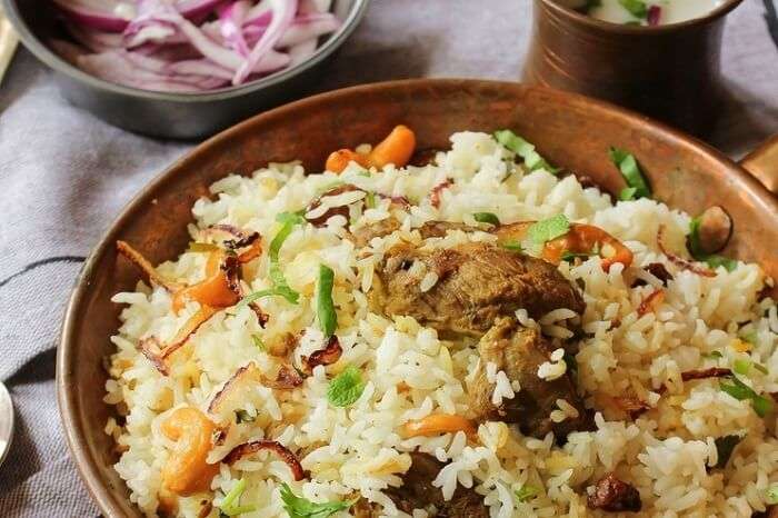 Thalassery Biryani, a fragrant Kerala biryani with tender meat, aromatic rice, and garnished with fried onions and nuts