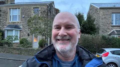 Simon Duffy Simon Duffy stands outside his stone-walled house in Sheffield.